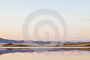 Lake Tuzkol in Kazakhstan and a view of Khan Tengri peak at sunrise