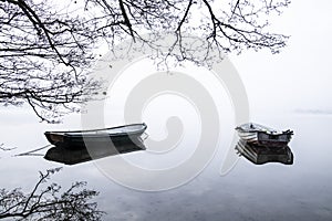 Two boats in quiet lake water