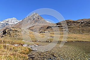 lake in Vanoise national Park in France with snowy mountain background