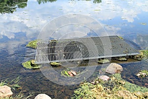 Lake vegetation clogging water runoff drain