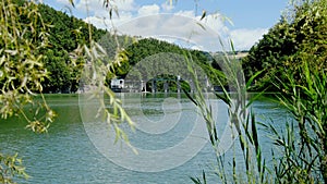 Lake view through branches tranquil scene reservoir artificial basin