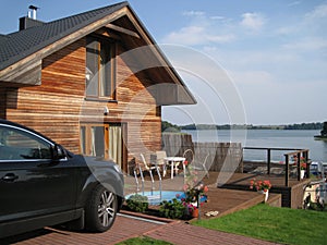 Lake view house with car and swimming pool