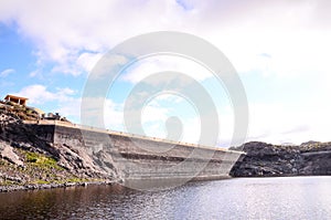 Lake water dam in canary islands in spain with a cloudy blue sky in the background photo