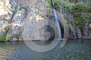 Lake and waterfall on the river beach of Pego set amongst the mountains of the Portuguese village of Penha Garcia, PR3 circuit