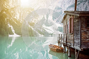 Lake in a wilderness nature. Braies lake in a italian dolomites. Sunrise in nature. Background. Wooden hut. Beautiful summer view