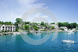 Lakefront homes and boats in the Round Lake in downtown Charlevoix Michigan