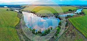 Lakes with reflection of sunset sky in agricultural fields