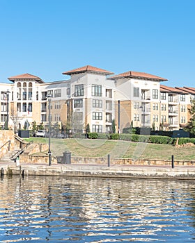 Lakeside apartment building complex with blue sky in America