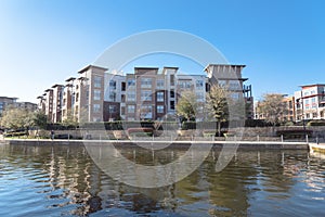 Lakeside apartment building complex with blue sky in America