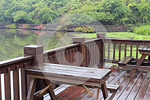 Lakeside wooden terrace in rain