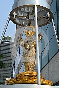 Lakshmi is one of the principal Hindu goddesses, depicted here as an elegant, golden-colored woman standing on a lotus throne