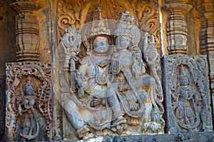 Lakshmi sitting in the lap of Vishnu. Hoysalesvara Temple, Halebid, Karnataka