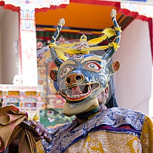 Buddhist lamas dressed in mystical mask dancing Tsam mystery dance in time of Yuru Kabgyat Buddhist festival at Lamayuru Gompa, La