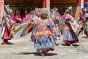 Buddhist lamas dressed in mystical mask dancing Tsam mystery dance in time of Yuru Kabgyat Buddhist festival at Lamayuru Gompa, La