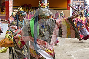 Buddhist lamas dressed in mystical mask dancing Tsam mystery dance in time of Yuru Kabgyat Buddhist festival at Lamayuru Gompa, La