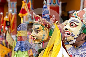 Buddhist lamas dressed in mystical mask dancing Tsam mystery dance in time of Yuru Kabgyat Buddhist festival at Lamayuru Gompa, La