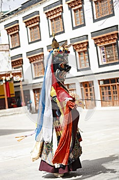 LAMAYURU, INDIA - SETEMBER 13, 2015: An unidentified buddhist lamas dressed in mystical mask dancing Tsam mystery dance in time of