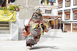 LAMAYURU, INDIA - SETEMBER 13, 2015: An unidentified buddhist lamas dressed in mystical mask dancing Tsam mystery dance in time of