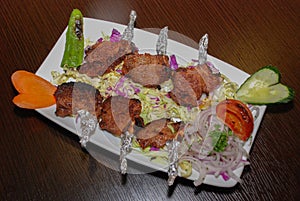 Lamb barbequed ribs with salad on the white plate