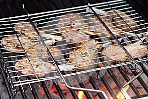 Lamb chops in grilling basket on grill