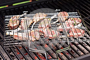 Lamb chops in grilling basket on grill