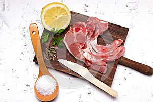 Lamb chops, lemon, salt and parsley photo