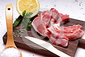 Lamb chops, lemon, salt and parsley photo