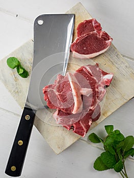 Lamb chops with meat cleaver and fresh mint