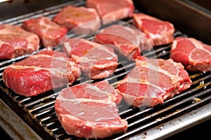 lamb chops probed for doneness on a flat iron grill