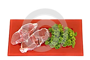 Lamb chops on red plate