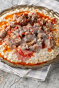 Lamb Keshkek Traditional Wheat and Mutton Stew closeup on the plate. Vertical