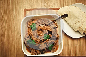 Lamb mutton Korma on a wooden background