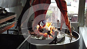 Lamb of Patagonia slowly roasted over the fire, typical dish of Chile and Argentina. Lamb to the post. Cordero al palo