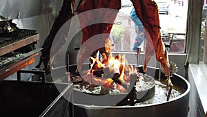 Lamb of Patagonia slowly roasted over the fire, typical dish of Chile and Argentina. Lamb to the post. Cordero al palo