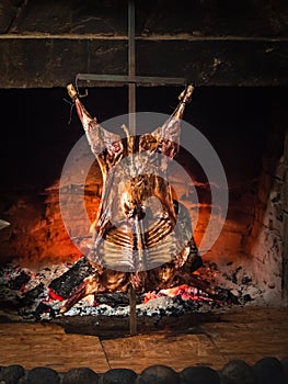 Lamb of Patagonia slowly roasted over the fire, typical dish of Chile and Argentina. Lamb to the post photo