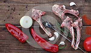 Lamb raw barbecue ribs, paprika and onions,garlic on dark rough boards, horizontal top view