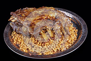 Lamb ribs on bulgur pilaf. Stuffed Ribs isolated on black background. Turkish name;