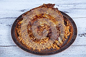 Lamb ribs on bulgur pilaf. Stuffed Ribs isolated on black background. Turkish name;