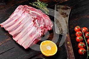 Lamb ribs cooking. Raw rack of lamb meat, on old dark  wooden table background
