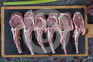 Lamb ribs cooking. Raw rack of lamb with spices and condiments. Uncooked mutton rack of lamb studio shot