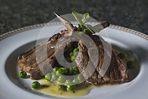 Lamb ribs with green peas photo