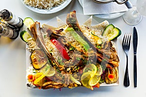 Lamb ribs with white rice, hummus and grilled vegetables