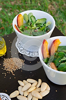 Lamb's lettuce salad in white dishes and its ingredients