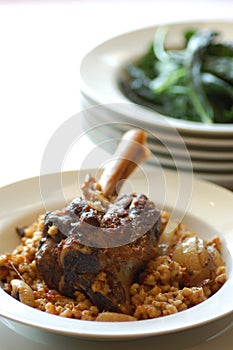 Lamb shanks with pearl barley & wilted greens