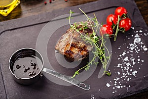 Lamb steak with cherry tomatoes and wine sauce. Delicious healthy traditional food closeup served for lunch in modern
