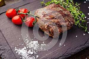 Lamb steak with cherry tomatoes and wine sauce. Delicious healthy traditional food closeup served for lunch in modern