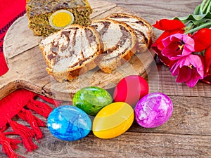 lamb tripe meat cake, sponge cake and colored easter eggs on table