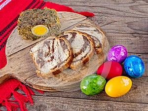 lamb tripe meat cake, sponge cake and colored easter eggs on table