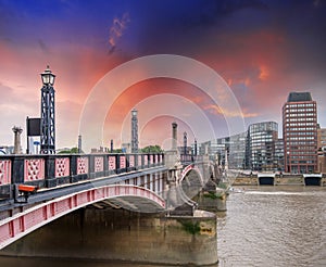 Lambeth Bridge, London. Beautiful red color and surrounding buildings at sunset