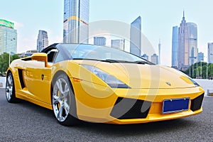A yellow Lamborghini in guangzhou skyline background